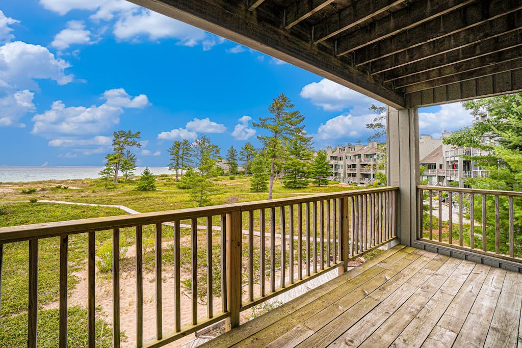 Lake-view condo with private beach, fireplace, deck, washer/dryer, streaming