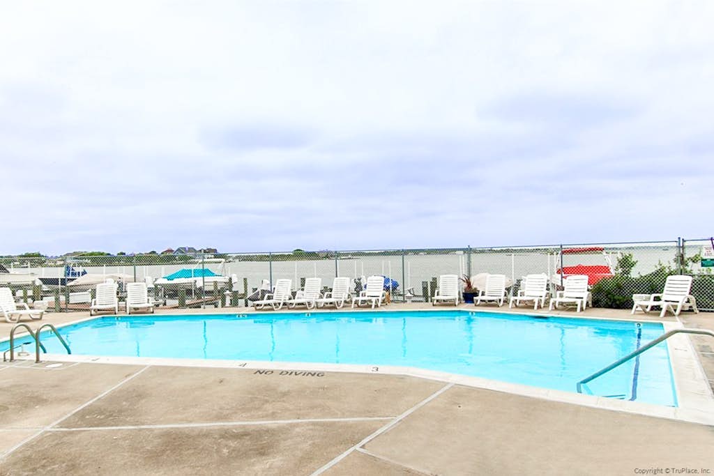 Waterfront condo with pool, balcony, fireplace, central AC, & washer/dryer