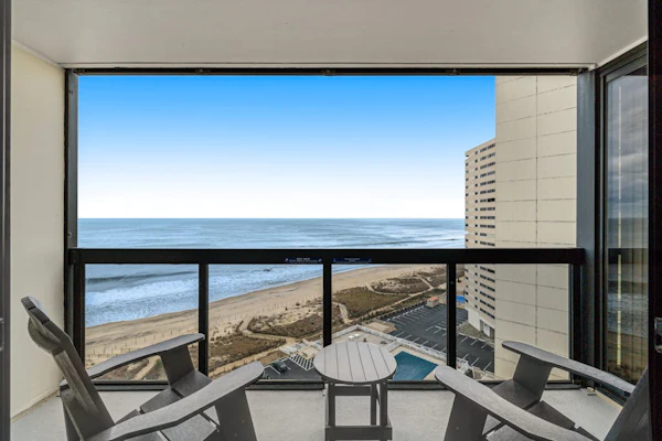 Coastal-themed beachfront condo with angled ocean views & pools