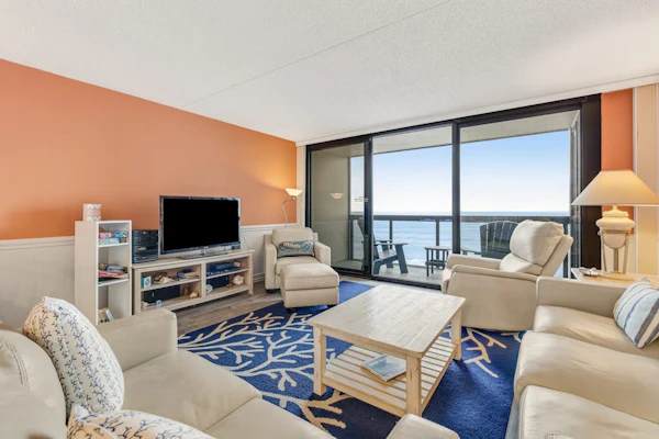 Coastal-themed beachfront condo with angled ocean views & pools