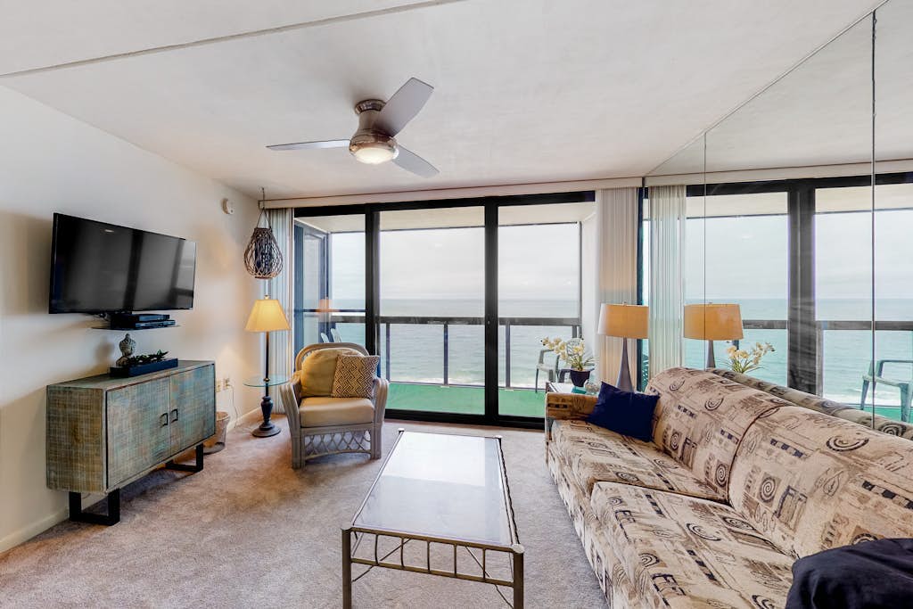 Waterfront condo with balcony, beach views, pools & gym