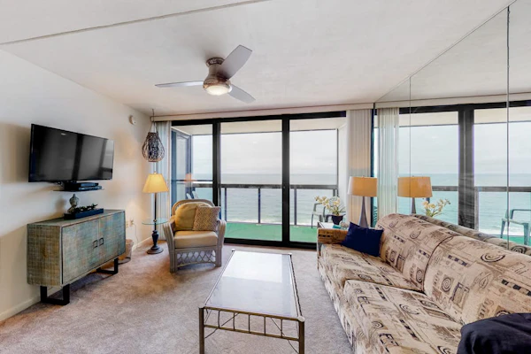 Waterfront condo with balcony, beach views, pools & gym