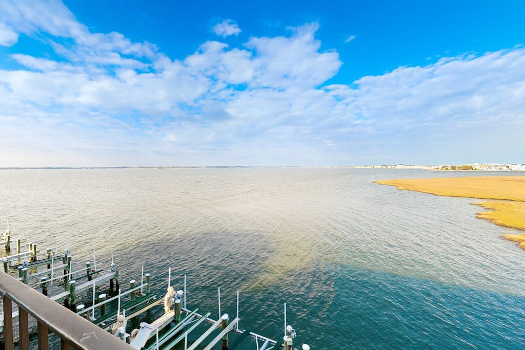 Two-Level Bayfront Condo with Amazing Sunsets, Balcony, WiFi & Shared Pool