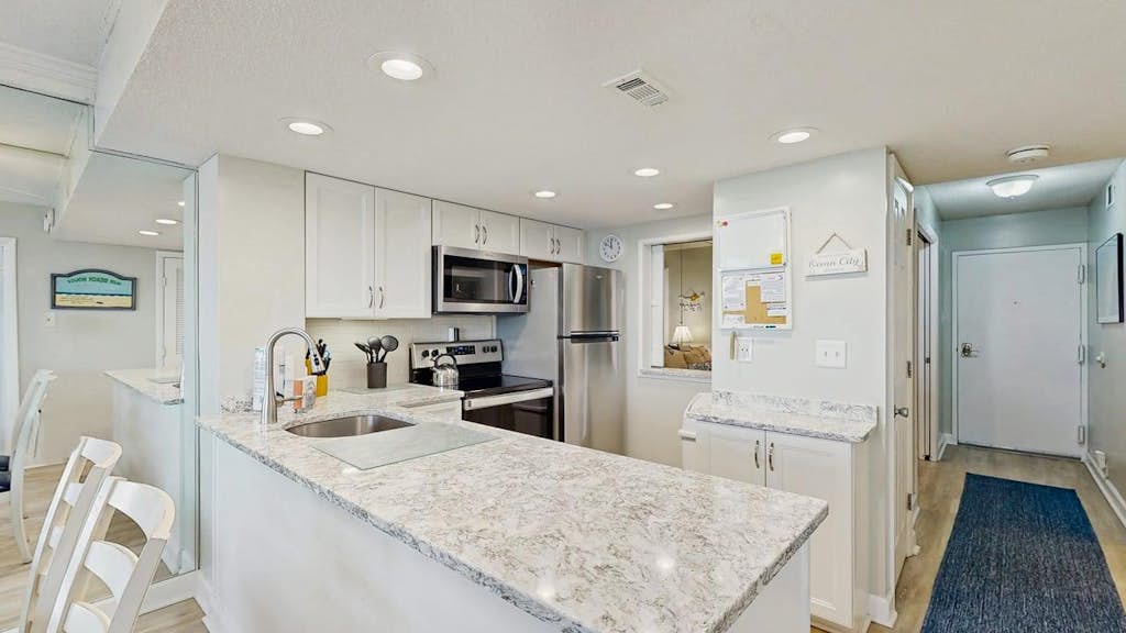 Sunny coastal condo with beach views, balcony, pools, gym, sauna & AC