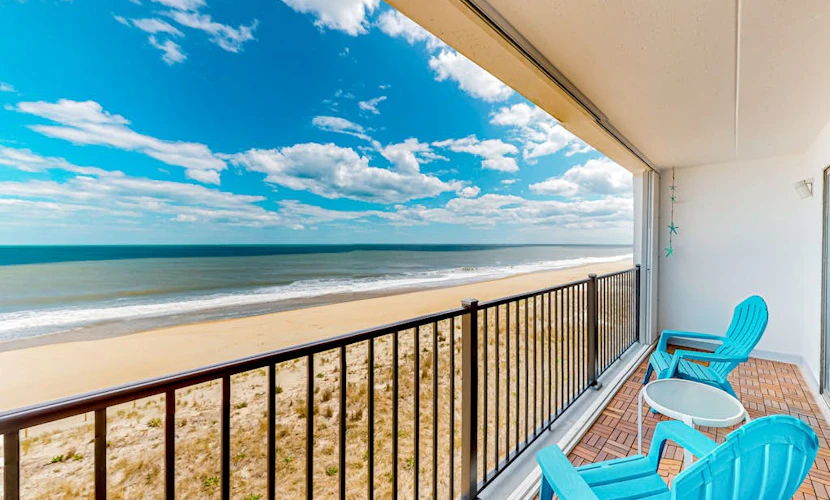 Beachfront condo with ocean views, private balcony, central AC, & W/D