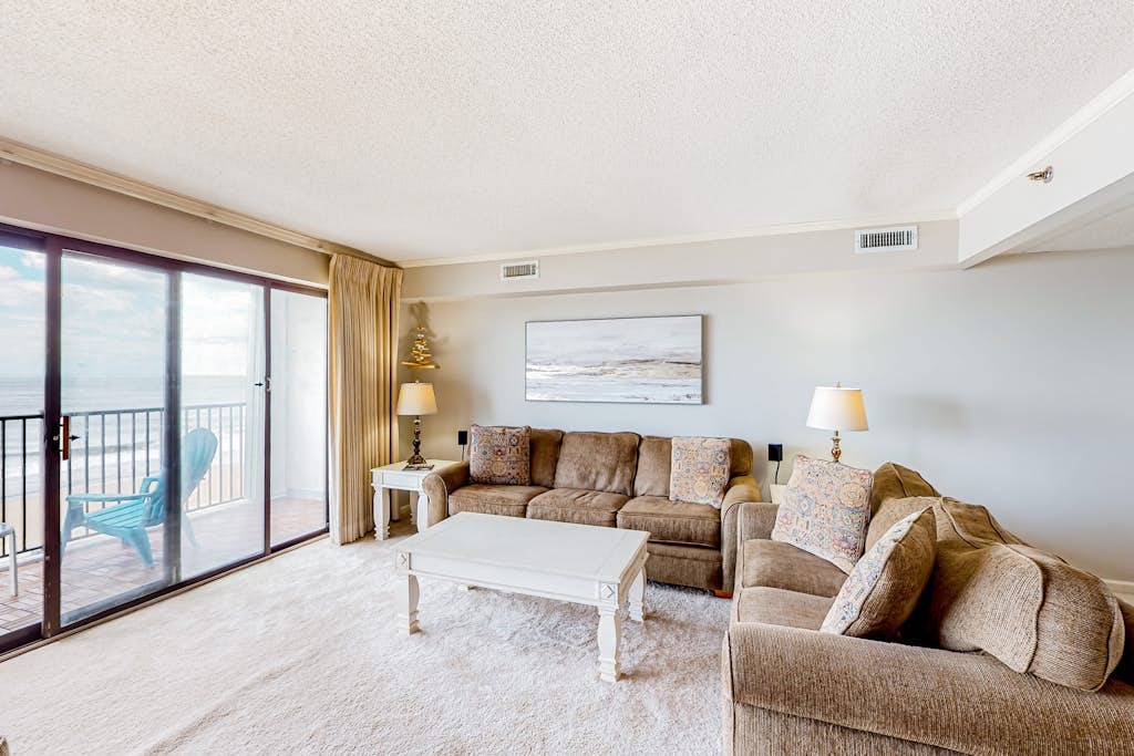 Beachfront condo with ocean views, private balcony, central AC, & W/D