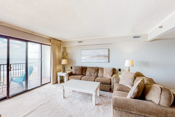 Beachfront condo with ocean views, private balcony, central AC, & W/D