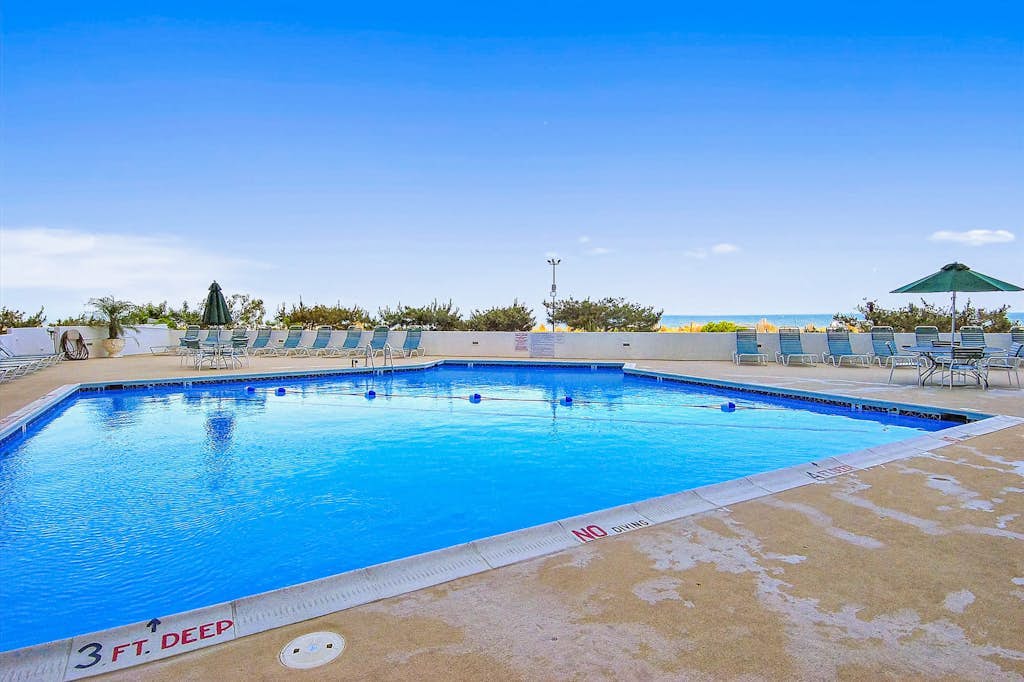 Oceanfront condo with a furnished balcony, central AC, washer/dryer, & pool