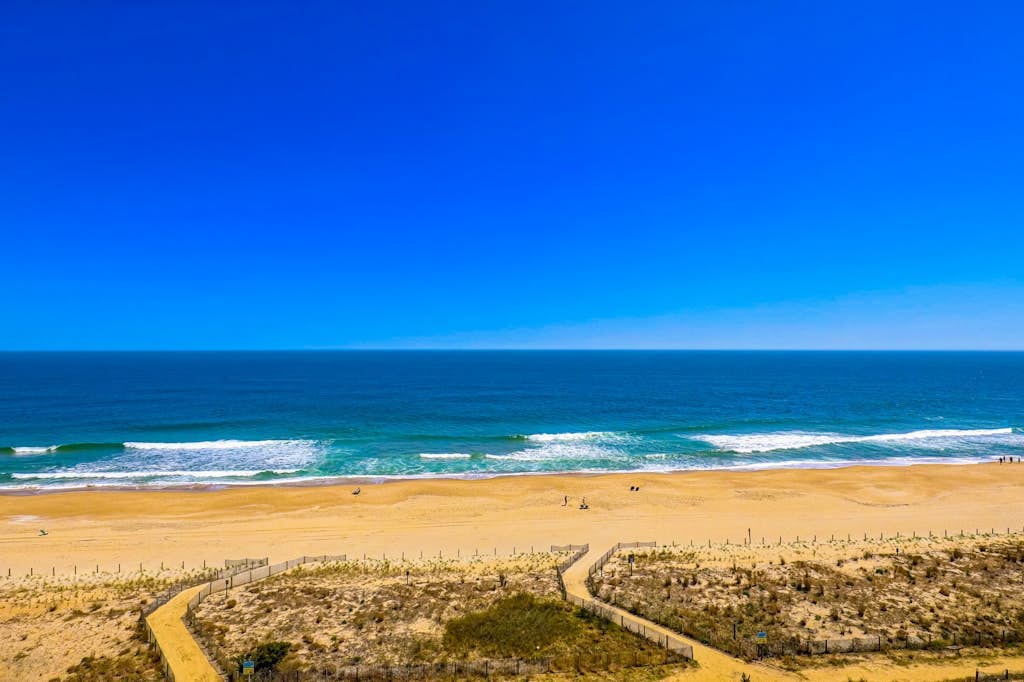 Oceanfront condo with a furnished balcony, central AC, washer/dryer, & pool