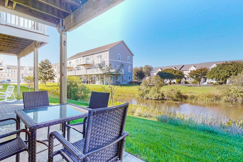 Dog-friendly, water-view townhome with shared pool, patio, grill
