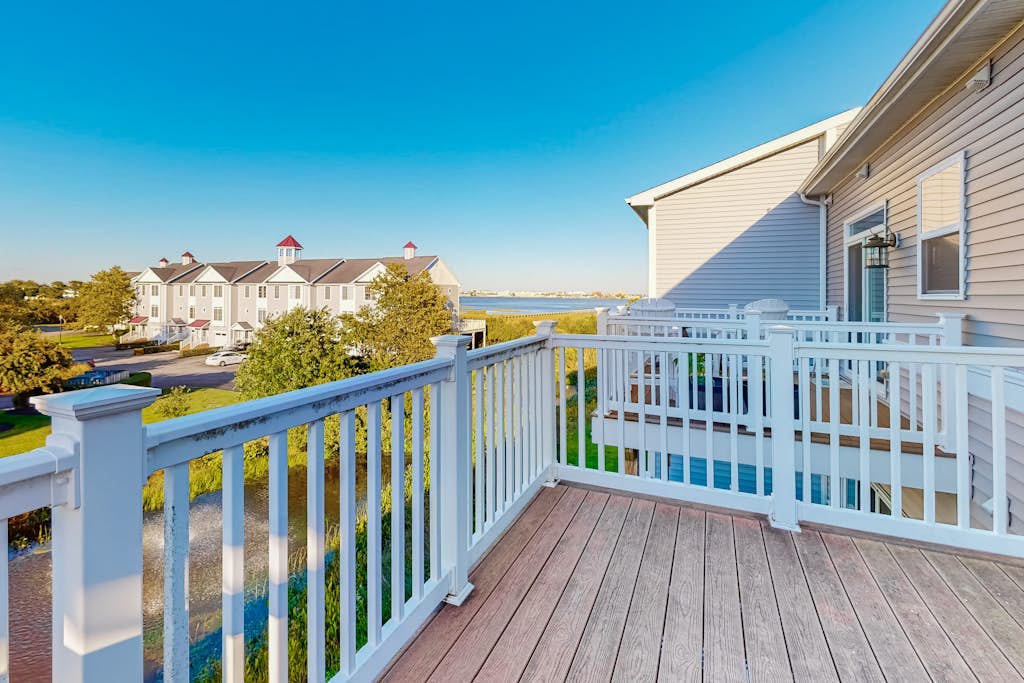 Dog-friendly, water-view townhome with shared pool, patio, grill