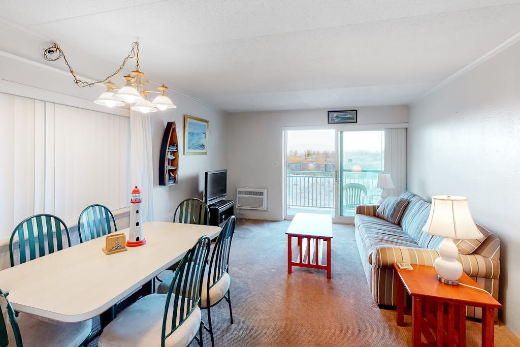 Partial Ocean View Condo in Oceanfront Building with Balcony, WiFi & Laundry