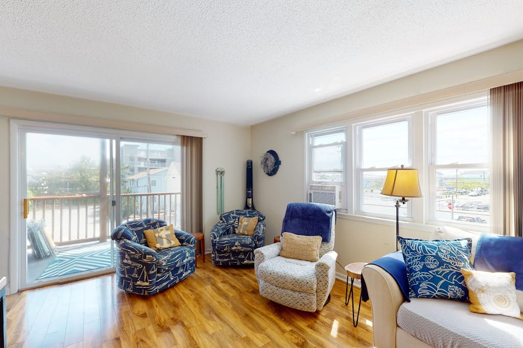 Nautical-themed condo with a balcony, open-layout, & W/D - steps from the sand
