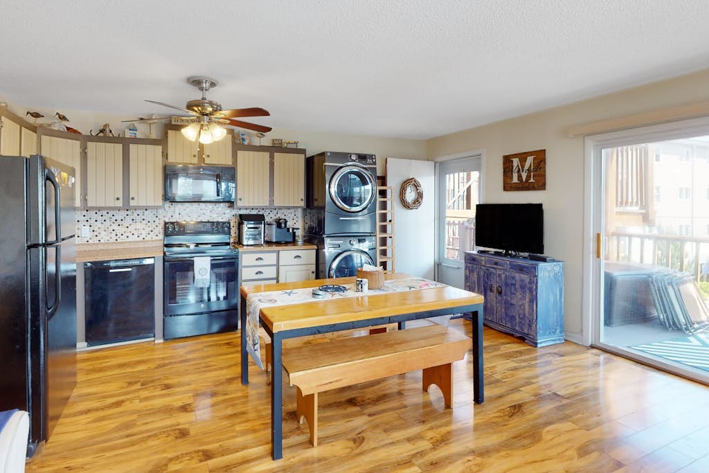 Nautical-themed condo with a balcony, open-layout, & W/D - steps from the sand