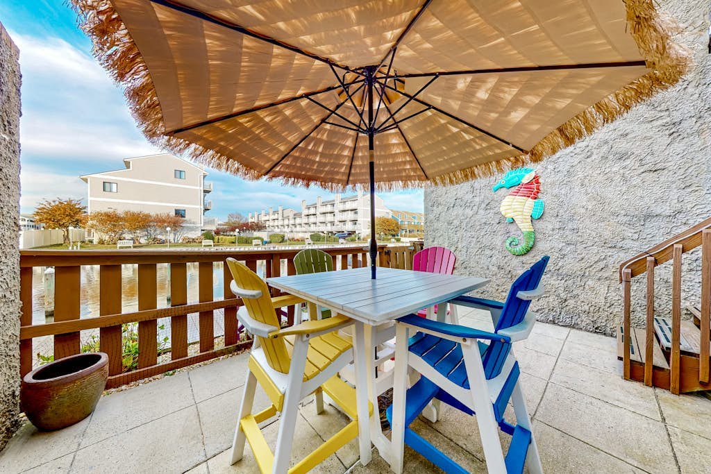 Canal-side condo near beach with water view, pool, private deck, & courtyard