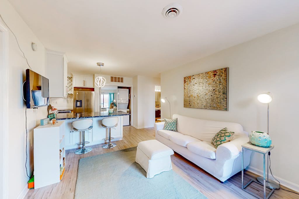 Canal-side condo near beach with water view, pool, private deck, & courtyard