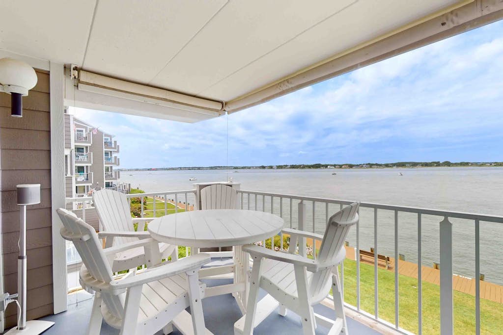 Luxury waterfront condo w/water views from balcony, shared pool, AC & free WiFi