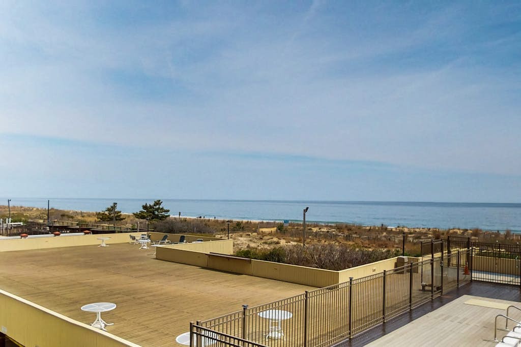 Sunny oceanfront condo with shared pool & deck, W/D, & direct beach access