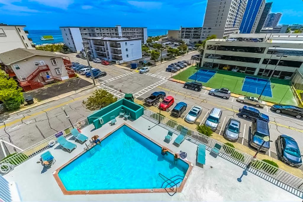 Coastal sanctuary with large deck, bay views, full kitchen, AC, & pool access