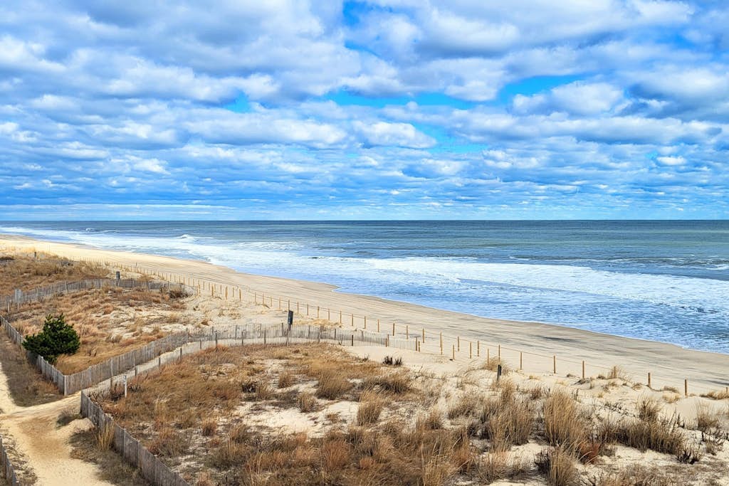 Coastal sanctuary with large deck, bay views, full kitchen, AC, & pool access