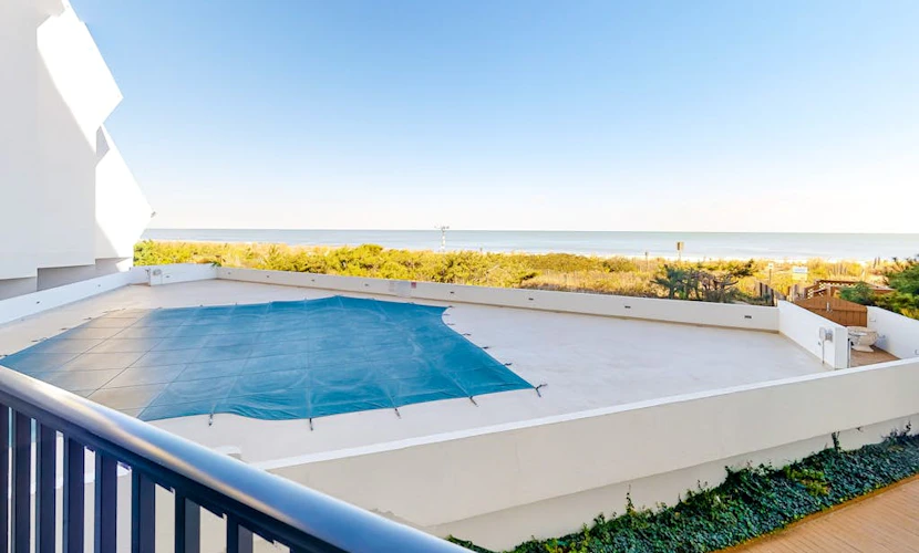 Oceanfront Condo with Covered Balcony, WiFi, AC, Laundry & Shared Pool