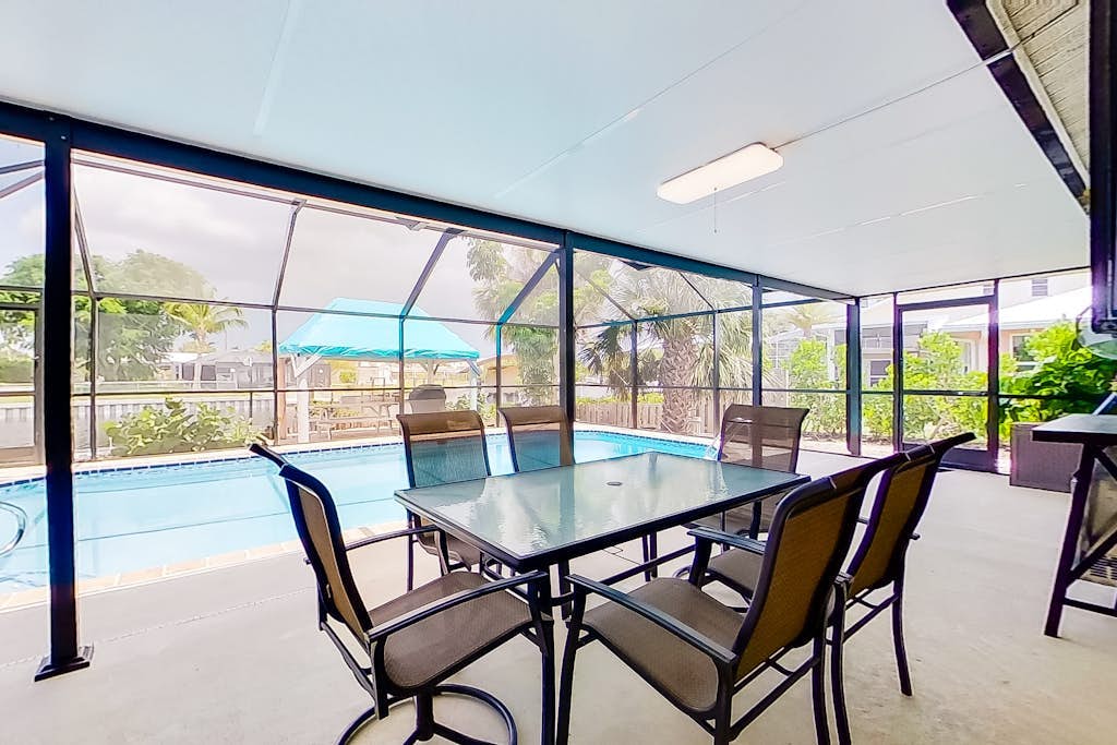 Private home on the canal with dock, screened pool, patio, AC, & W/D - dog-friendly