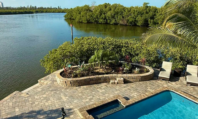 Immaculate bay front home w/in ground pool, spa, paver patio & porch