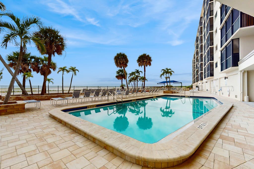 Beachfront condo with screened balcony, community pool, and internet