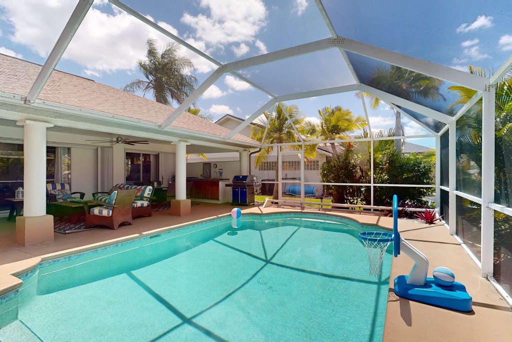 Waterfront home with private, heated pool, dock, and lanai