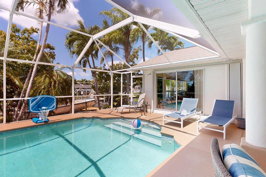 Waterfront home with private, heated pool, dock, and lanai