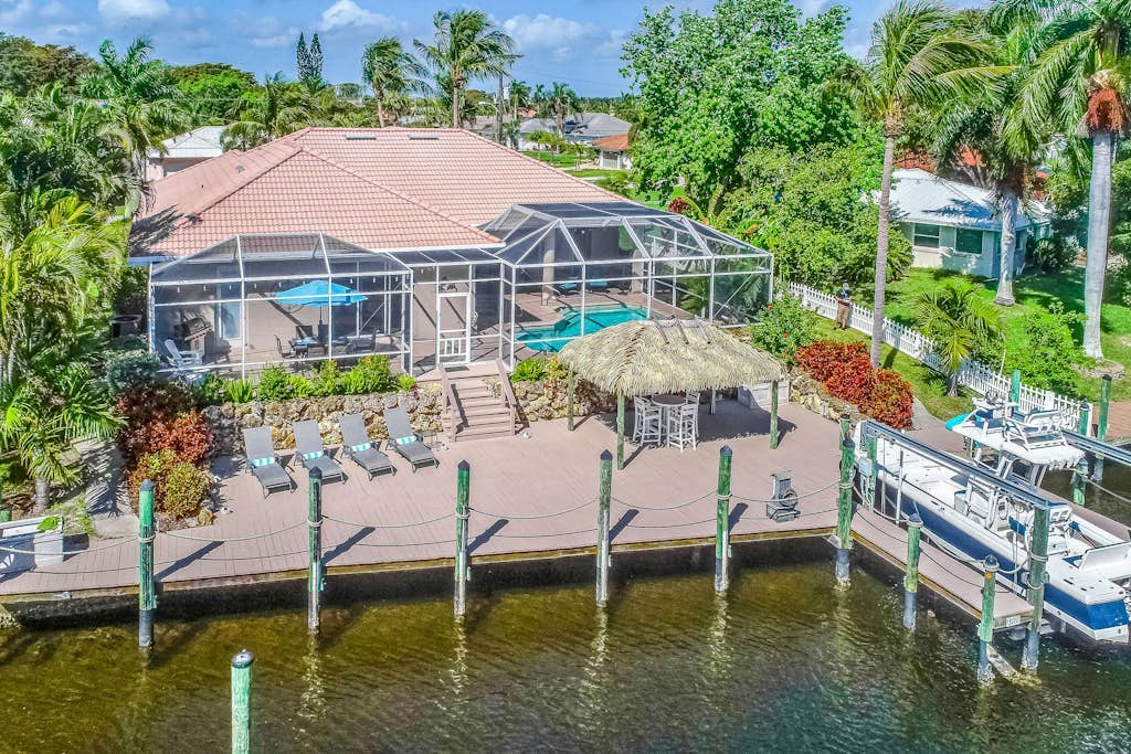 Custom waterfront home w/ dock, heated pool, AC & amazing indoor/outdoor spaces