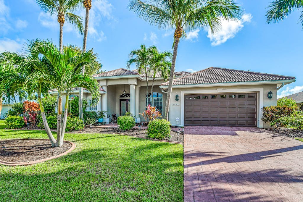 Custom waterfront home w/ dock, heated pool, AC & amazing indoor/outdoor spaces