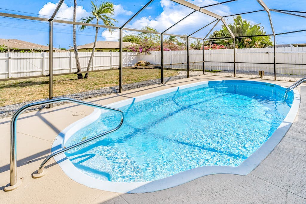 Snowbird-friendly home with enclosed yard, pool, patio, AC, & WiFi - 2 dogs OK