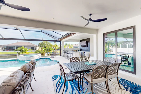 Luxury canal front home with heated pool, pool spa, grill, fireplace, W/D, & AC