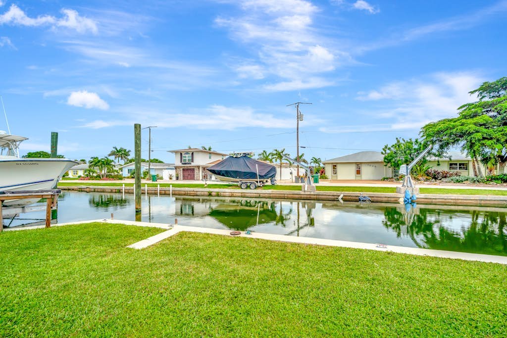 Waterfront home with canal access, patio, sun room, & central AC - near beach