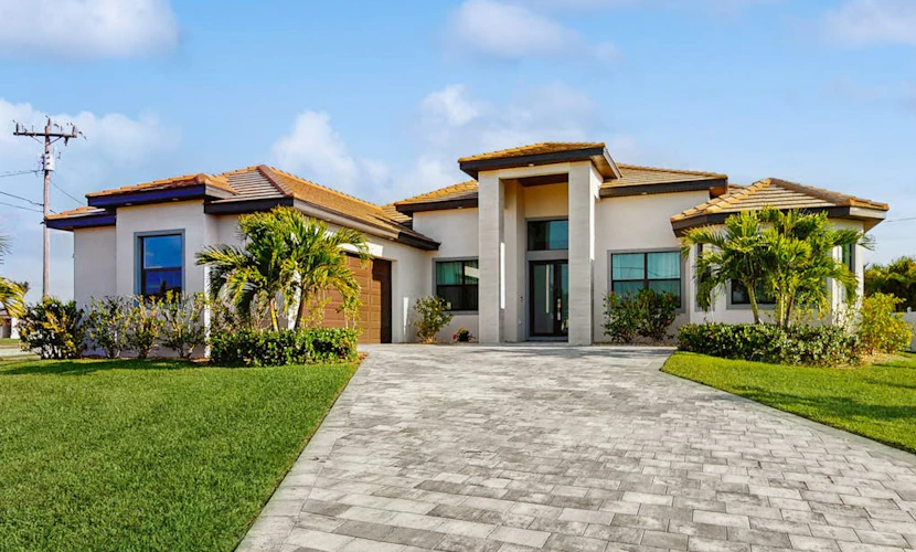 Modern canal-front luxury with pool, patio, grill, dock, Ping-Pong, AC, & WiFi