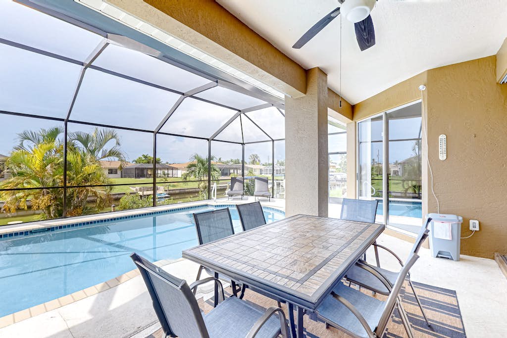 Waterfront home with screened pool, patio, grill, foosball, AC, & W/D
