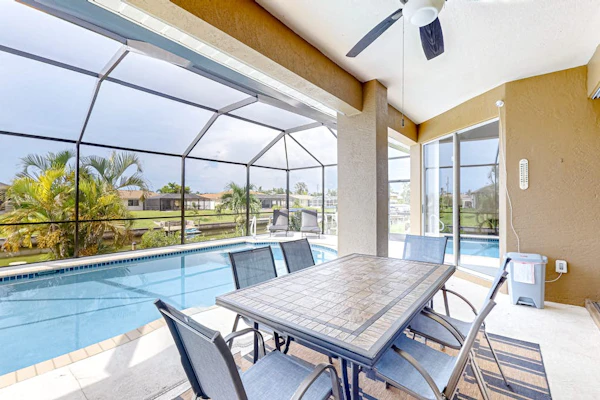 Waterfront home with screened pool, patio, grill, foosball, AC, & W/D