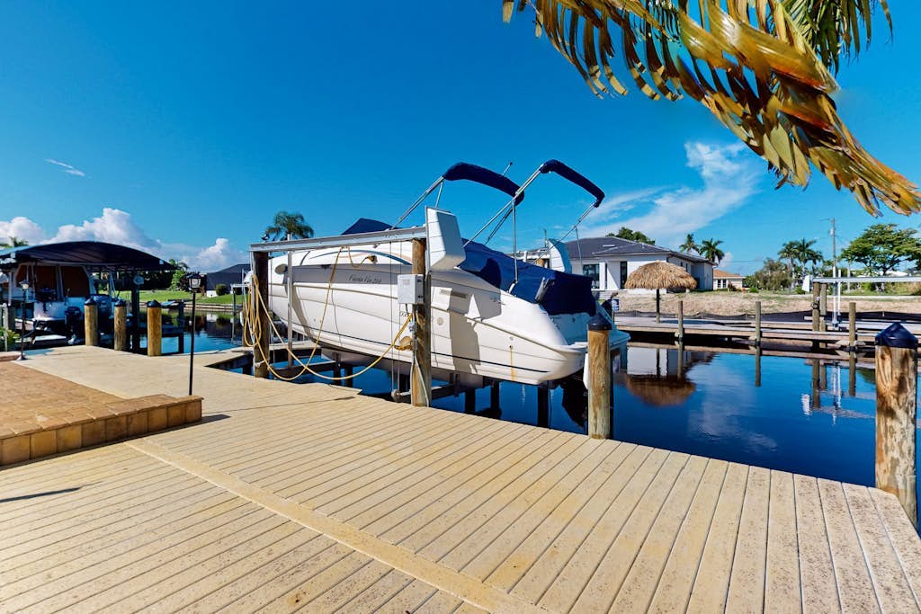 Canal-front home with private heated pool, dock, river views, patio, grill & W/D