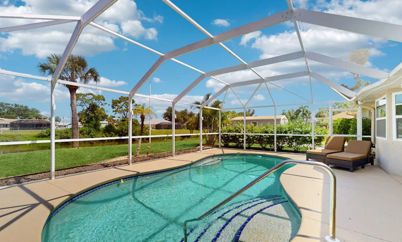 Snowbird-friendly home with private pool, water views, patio & sunroom
