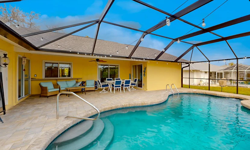 Renovated dog-friendly home near beach with private pool, screened lanai, grill