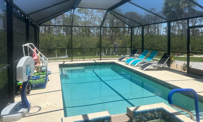 Outdoor paradise on waterway with pool and spa, beach gear, and dog friendly