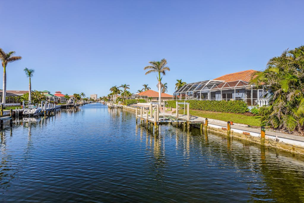 Large corner lot home with canal views & screened in pool - close to the beach