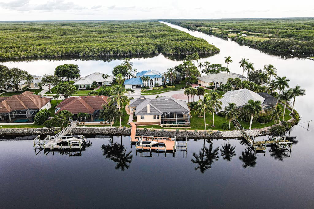 Upscale waterfront home with private dock, saltwater pool, lanai, grill, & W/D