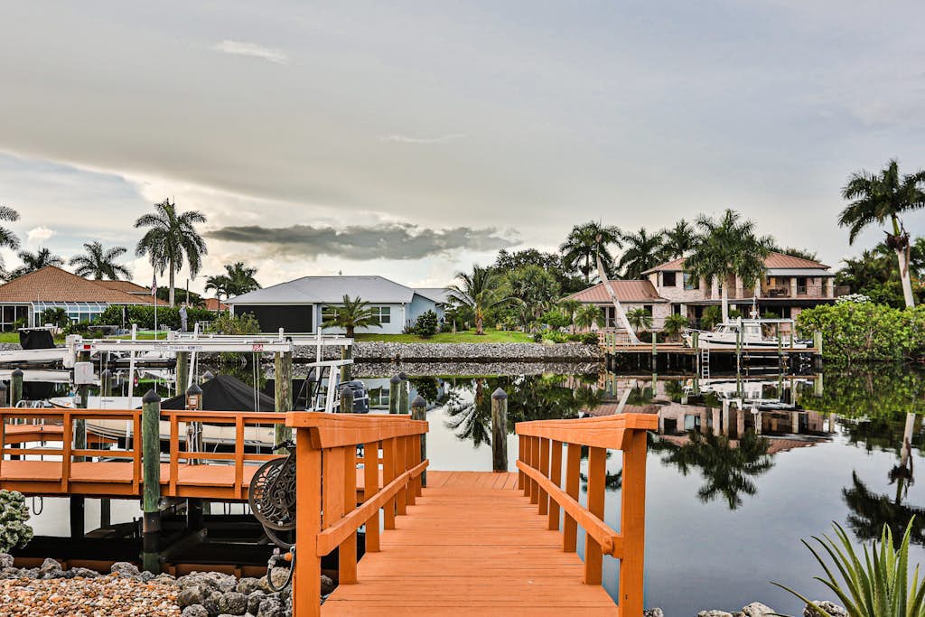 Upscale waterfront home with private dock, saltwater pool, lanai, grill, & W/D