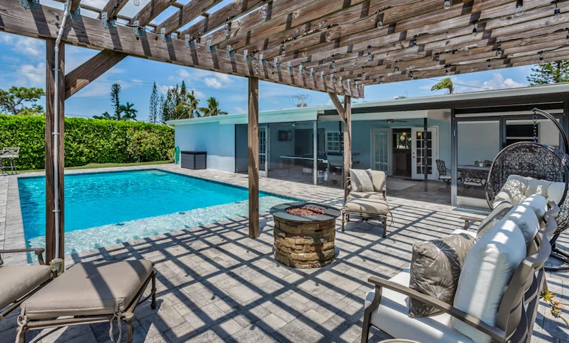 Inviting retreat with a large yard, heated pool, firepit, games & modern charm