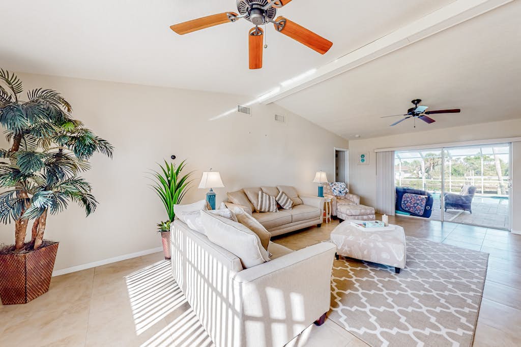Waterfront home with an enclosed pool, outdoor kitchen, and grill - dog-friendly