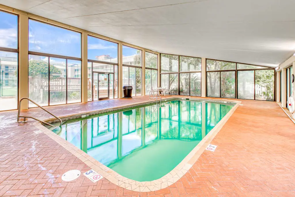 Gulf-view condo with central AC, WiFi, laundry, pools, gym & tennis