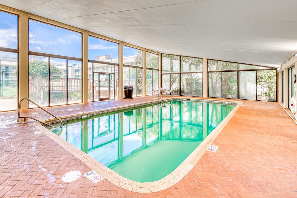 Gulf-view condo with central AC, WiFi, laundry, pools, gym & tennis