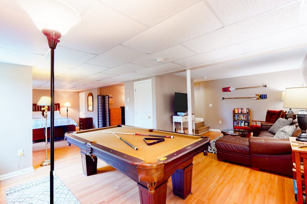 Sunny, Cape-style home with a game room, yard, firepit, & washer/dryer